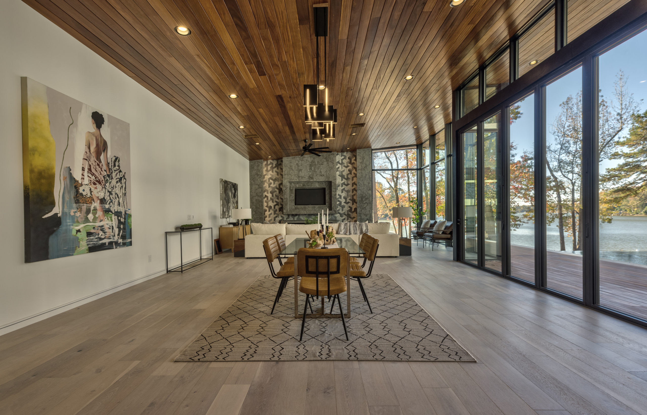 A dining room with wood floors and a fireplace.