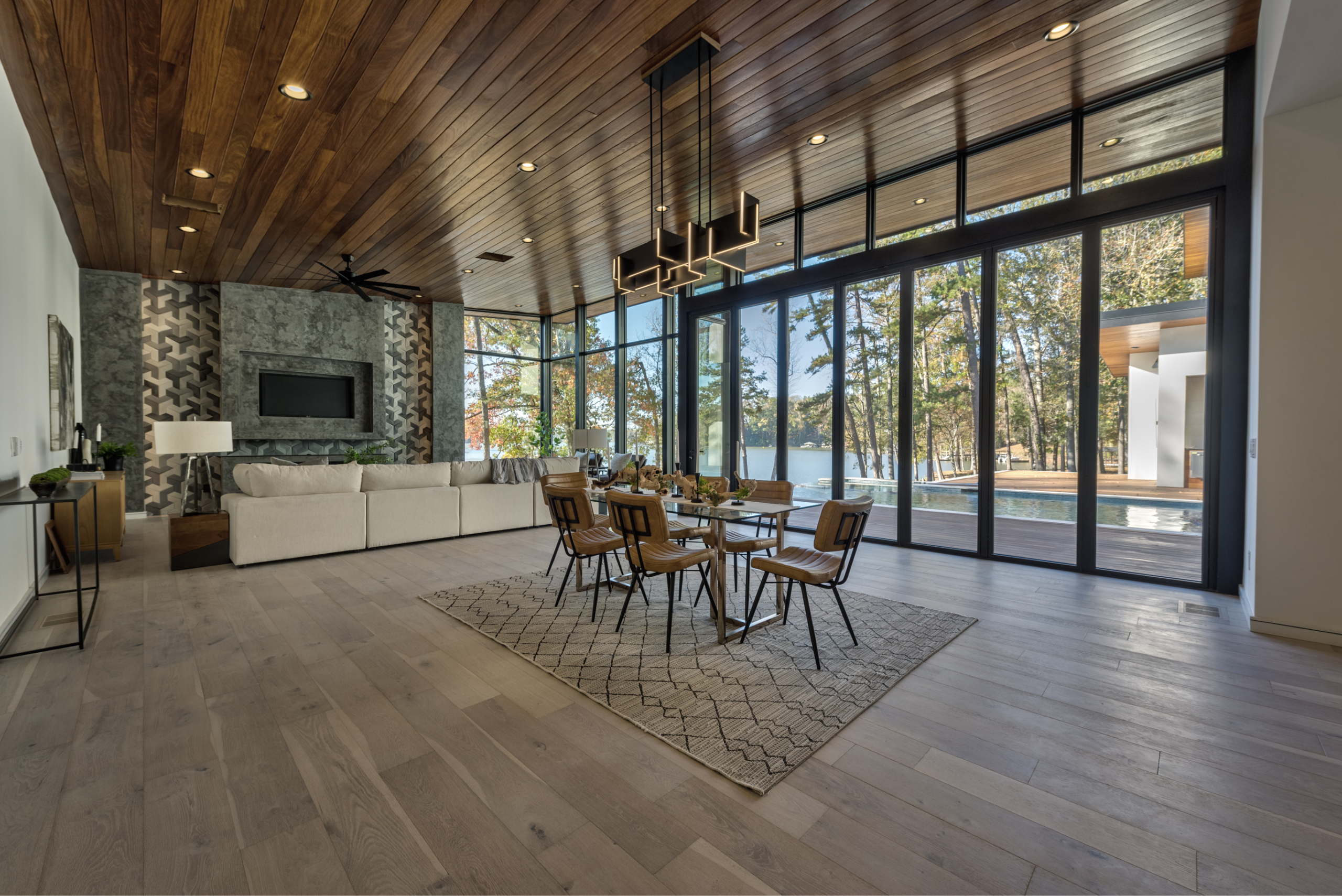 A dining room with a fireplace and a large glass door.