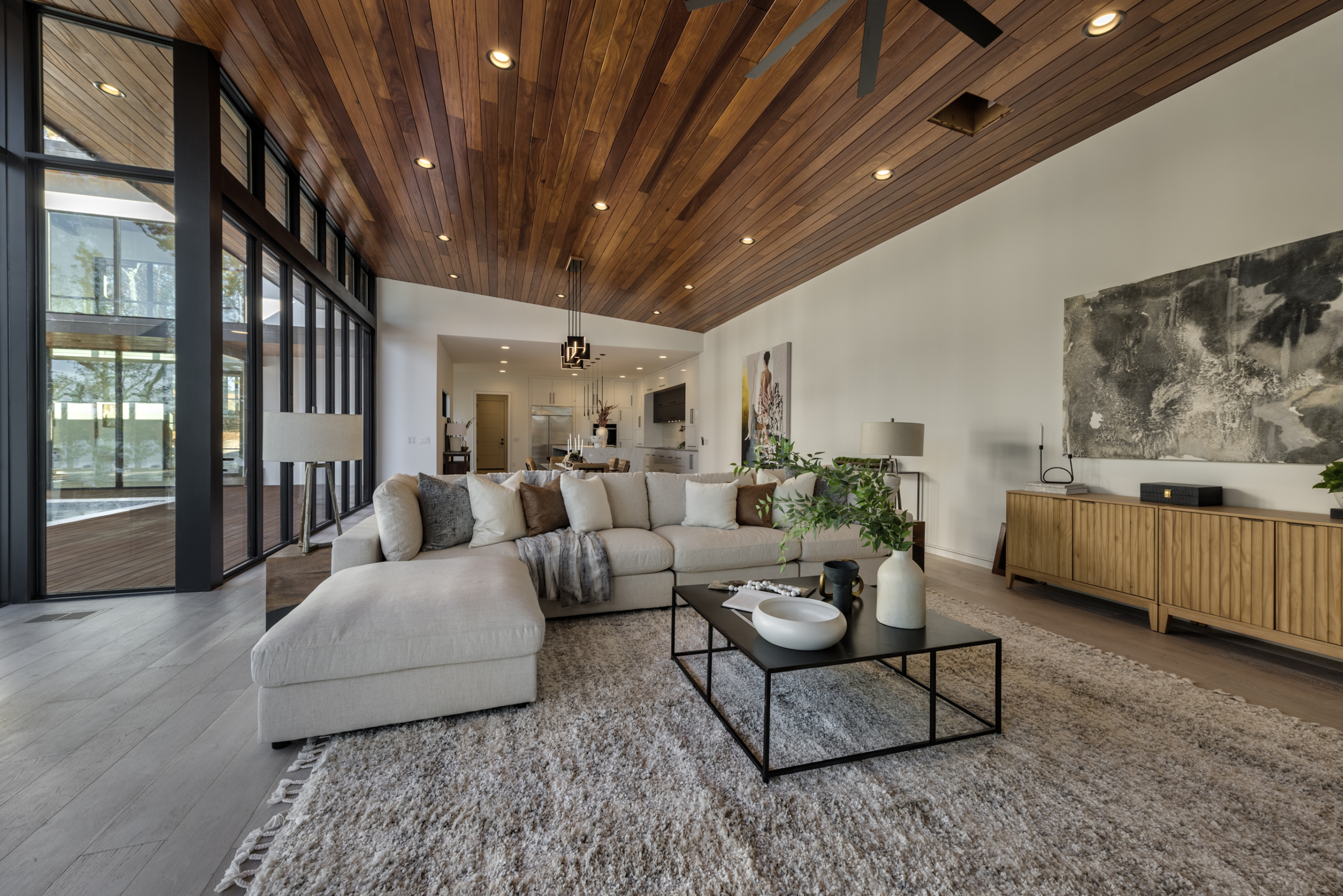Contemporary living room with wood cumaru ceiling and folding glass wall
