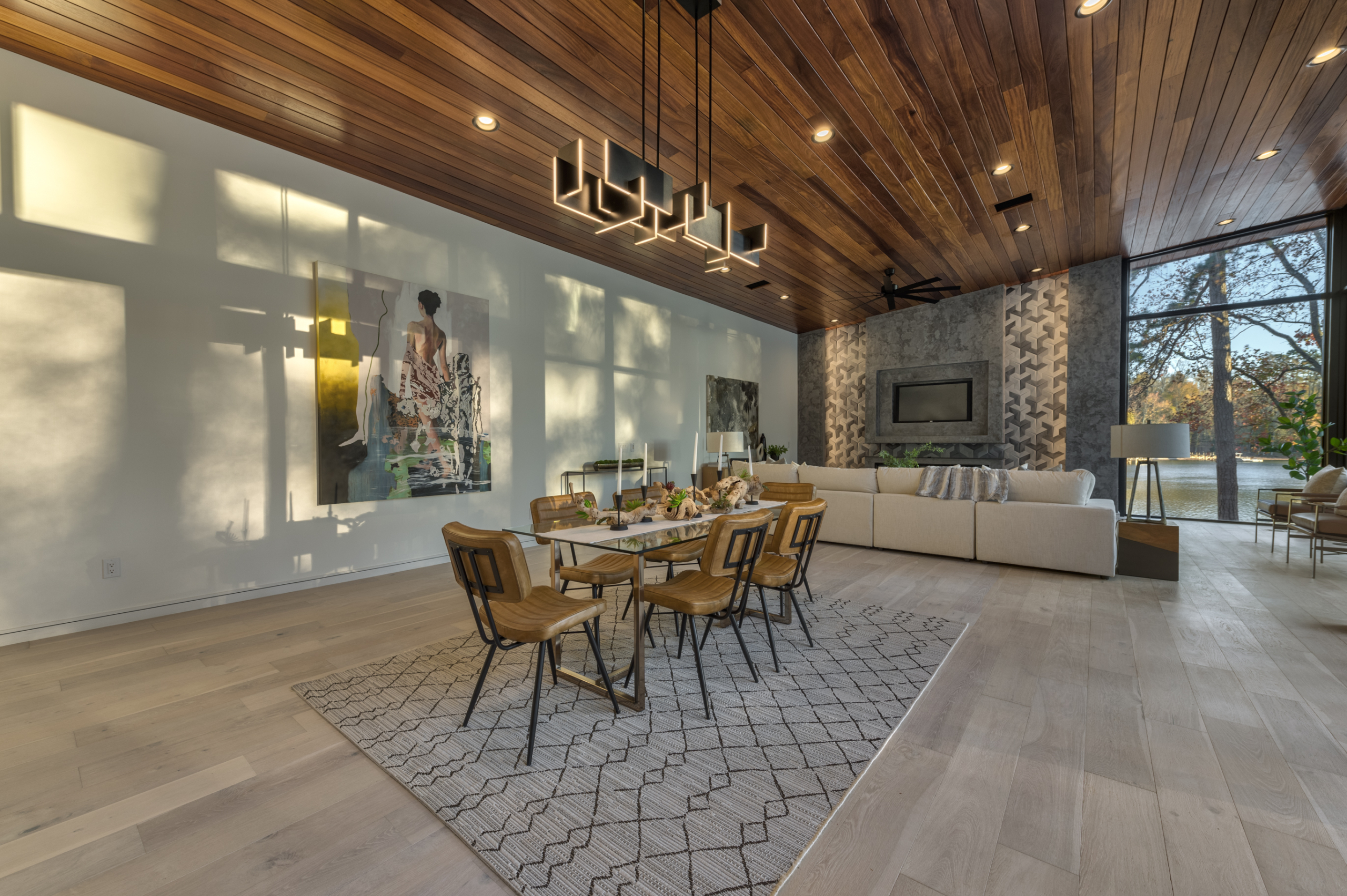 A dining room with a table and chairs, couch and wall.