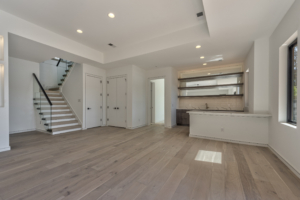 A large open room with white walls and wooden floors.