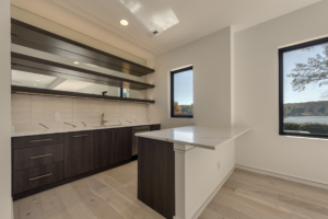 A kitchen with white walls and wooden floors.