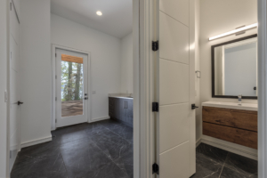 A bathroom with a tub and a door.