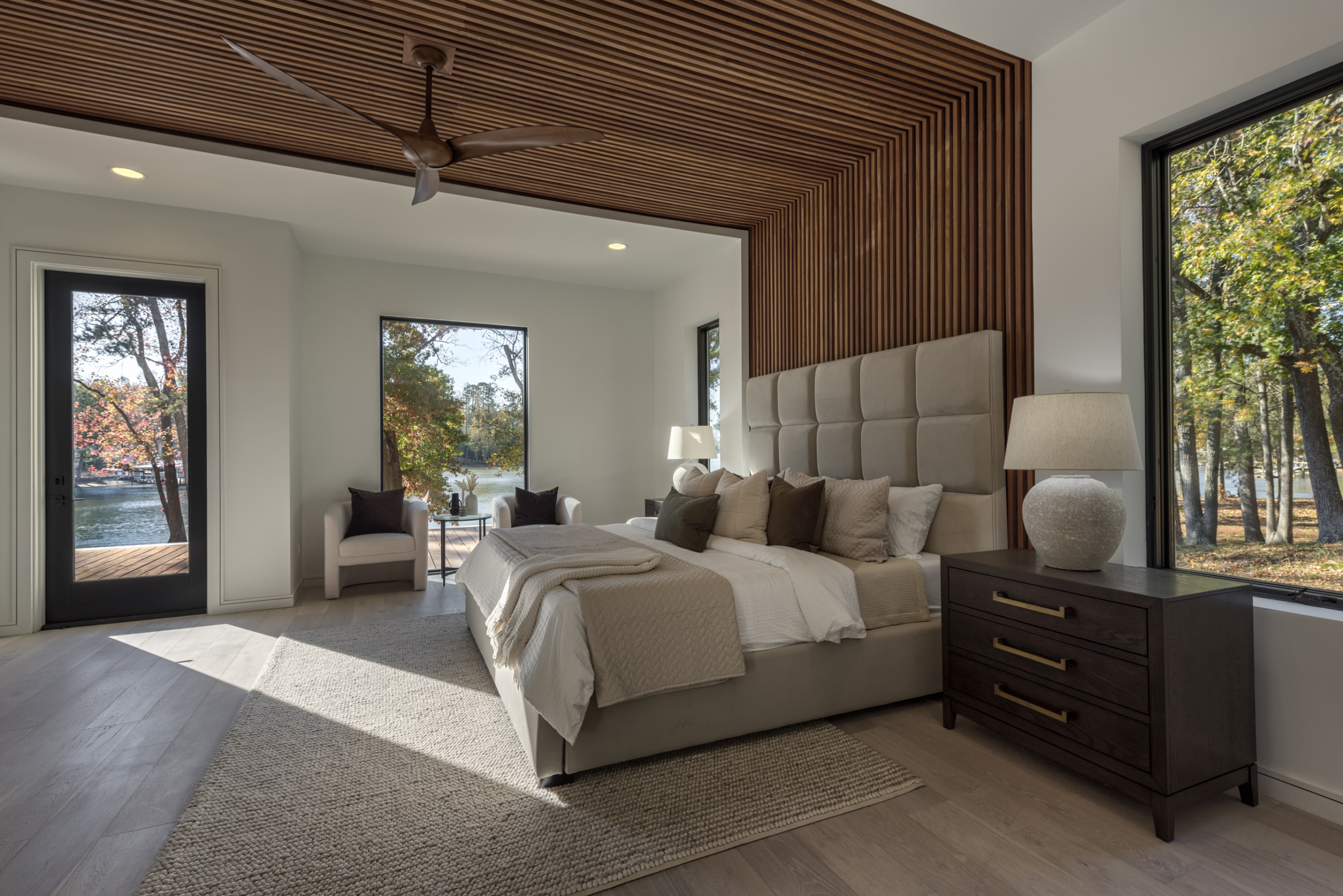 A bedroom with a large bed and wooden walls.