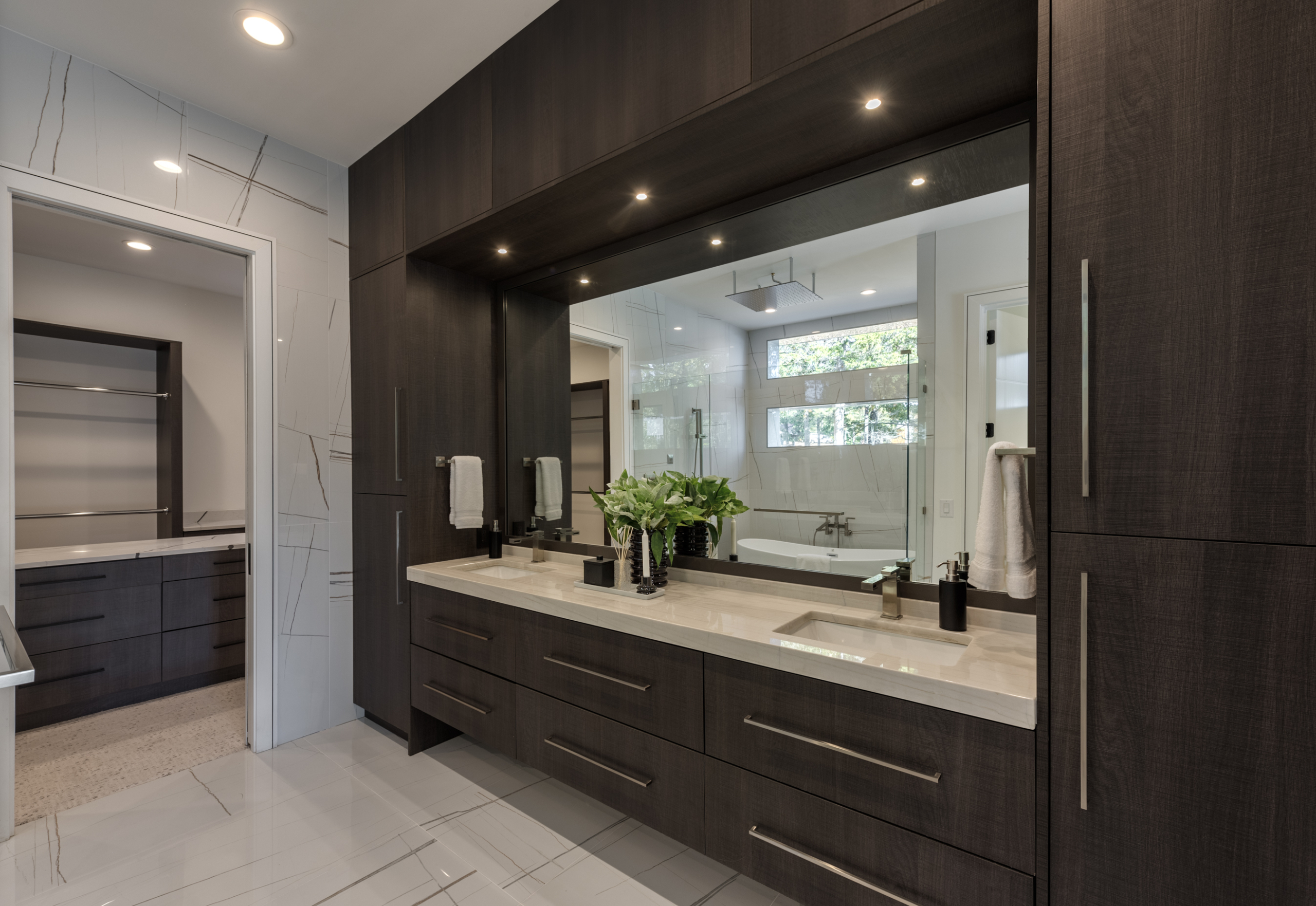 Modern Primary Bathroom with custom wood and marble double vanity and walk in closet