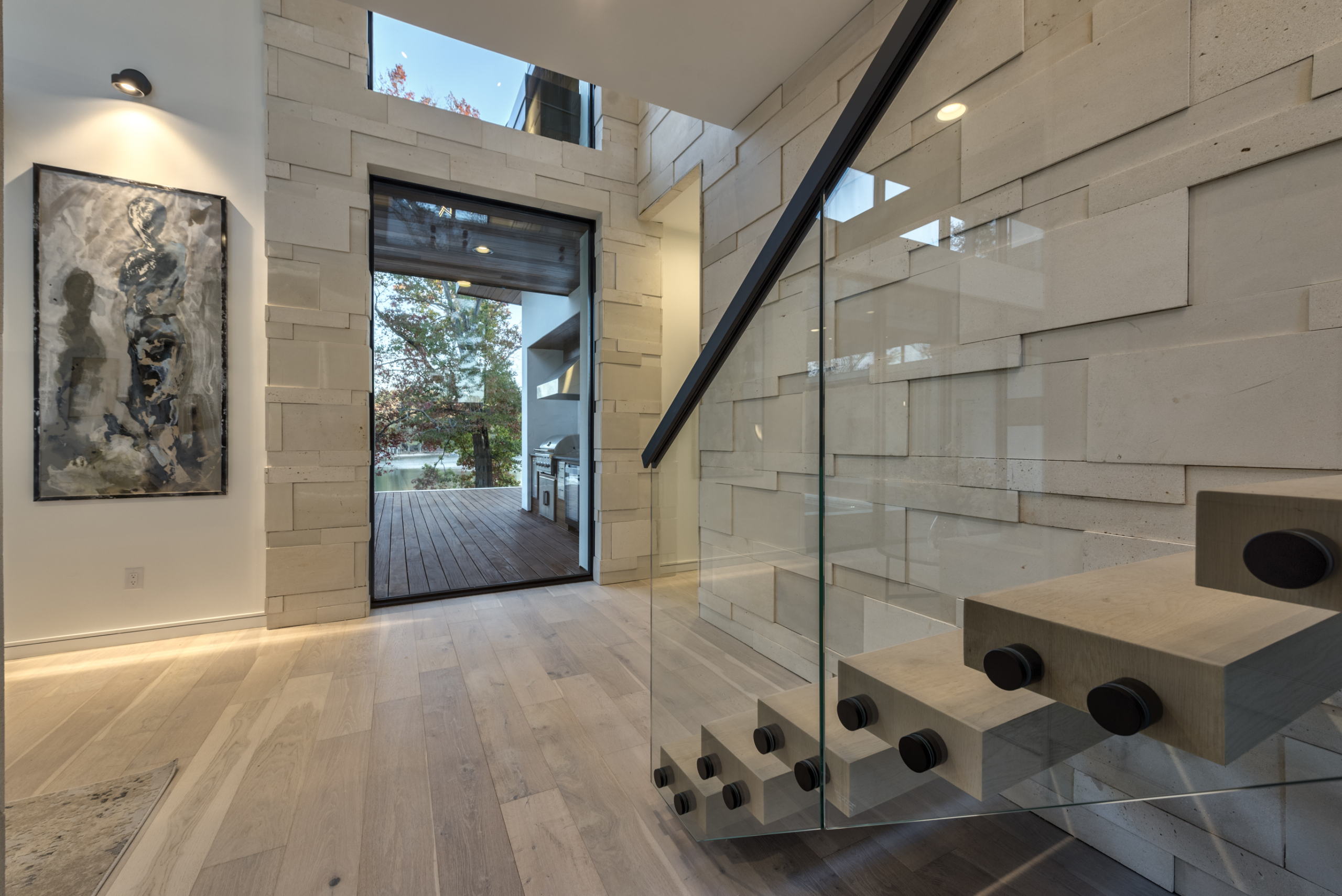 A glass staircase with a view of the outside.