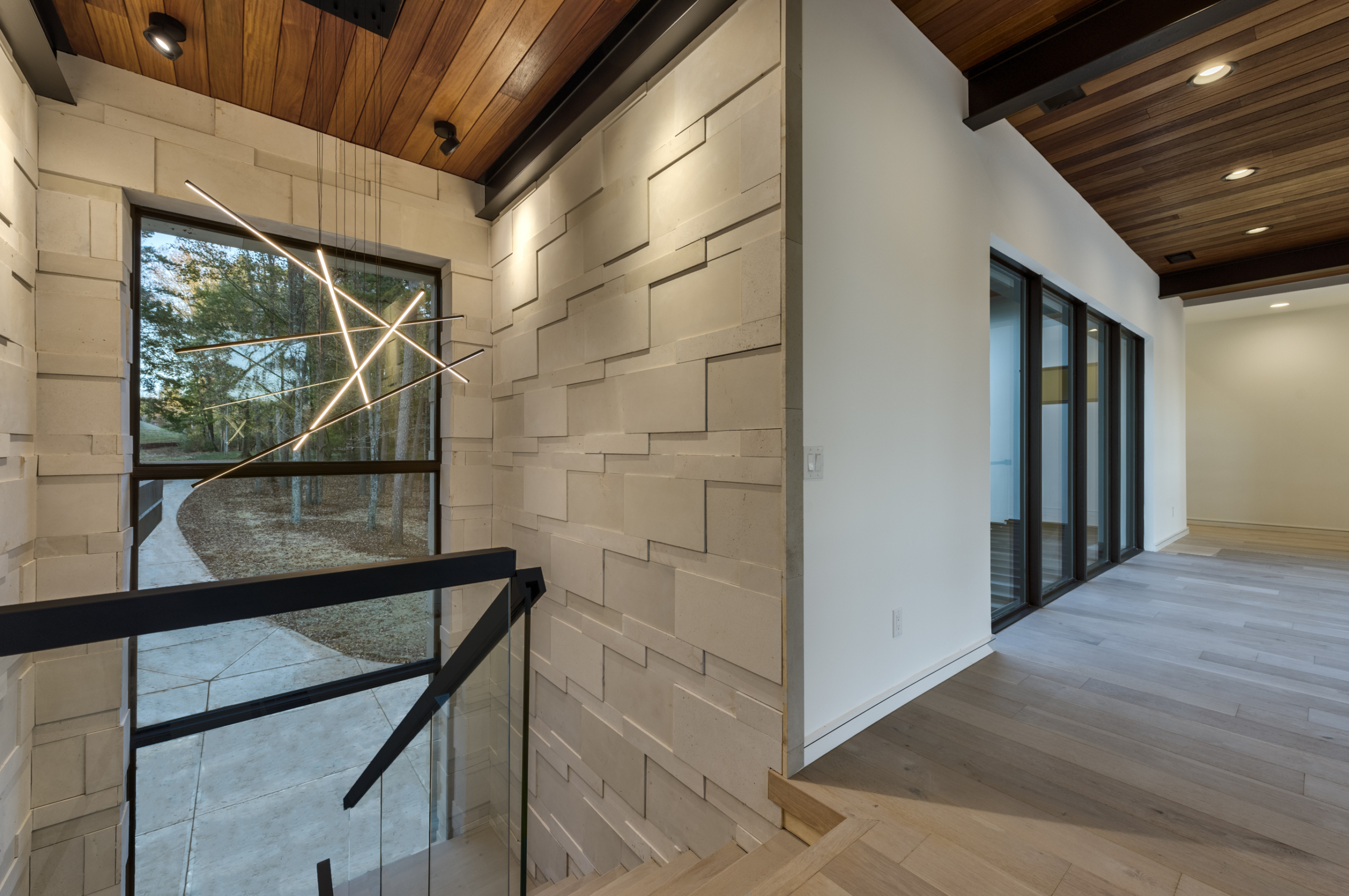 A room with a glass wall and a large window.