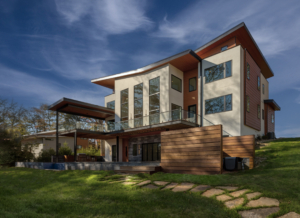A large modern house with a glass balcony.