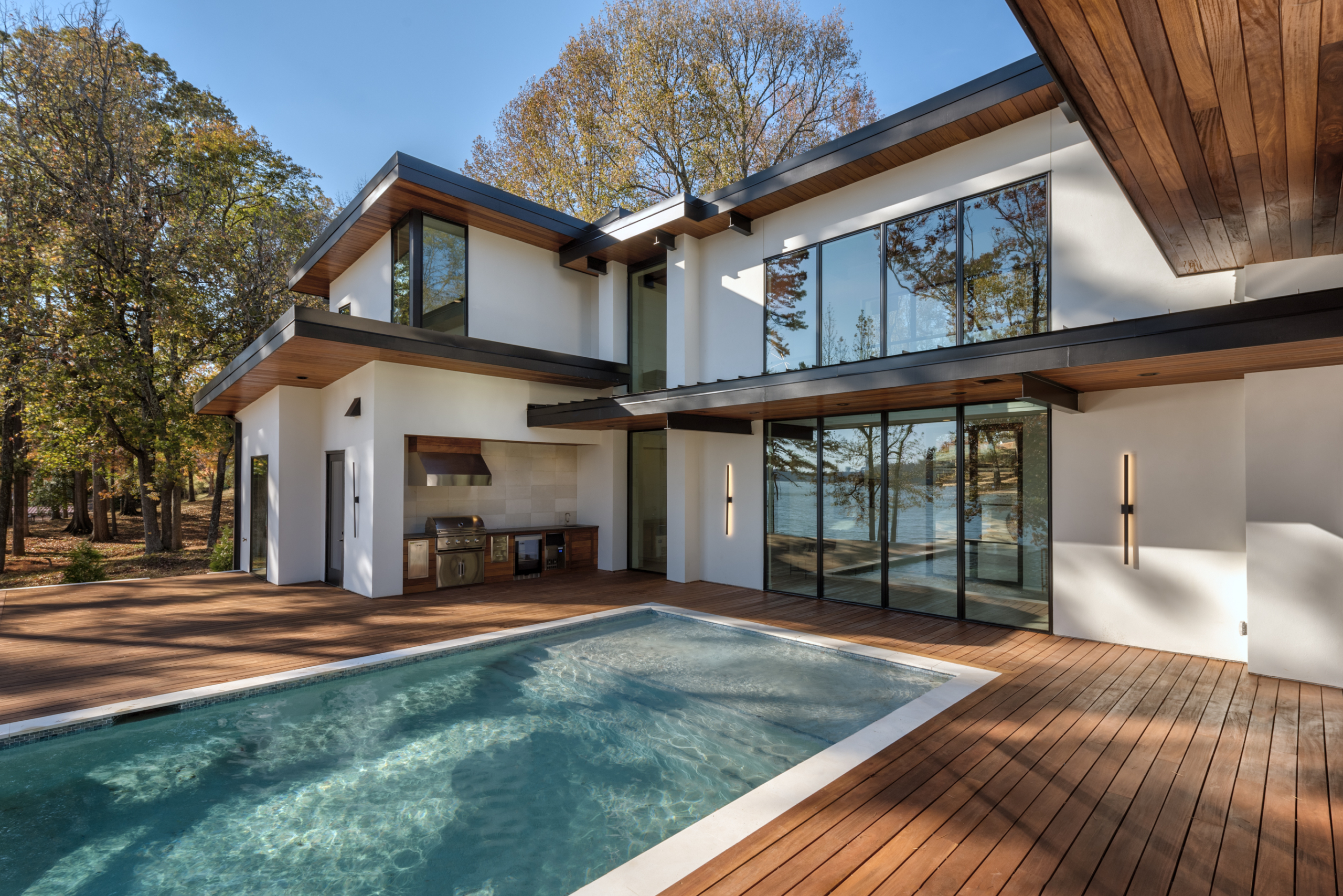 A large pool in front of a house.