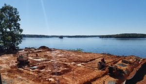 A person sitting on top of a dirt ground.