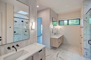 A bathroom with two sinks and a large mirror.