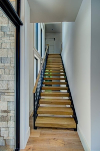 A long wooden staircase with metal railing.
