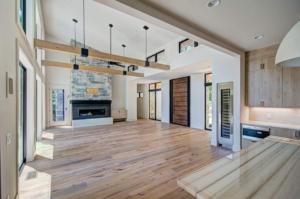 A large open living room with wood floors and fireplace.