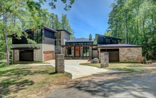 A large house with many trees in the background