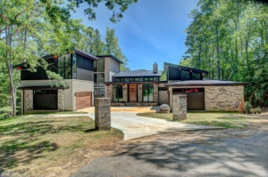 A large house with many trees in the background