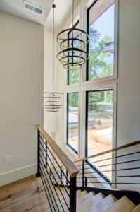 A staircase with two lights and a window.