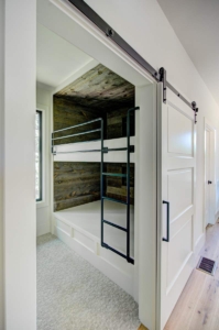 A room with two bunk beds and a door.