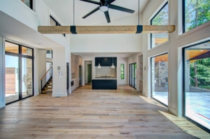 A large open floor plan with wood floors and a ceiling fan.