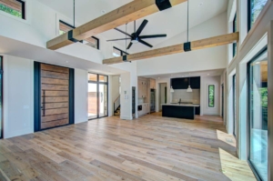 A large open room with wooden floors and ceiling beams.