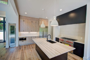 A kitchen with wood floors and white walls.