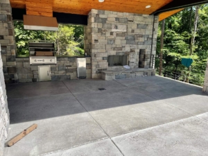 A large outdoor fireplace in the middle of an open area.