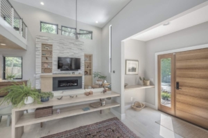 A living room with white walls and fireplace.