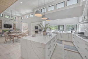 A large white kitchen with a big island