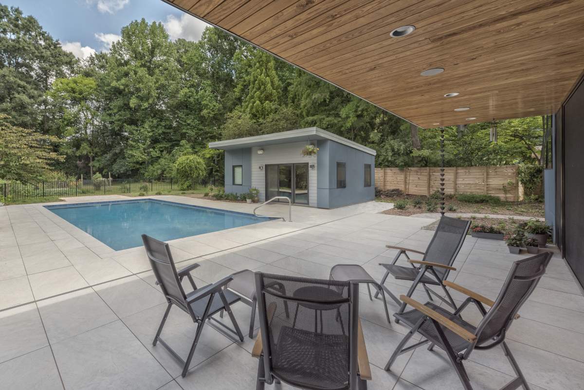 Modern backyard with pool and utility shed for exercise room, guest house, or bar