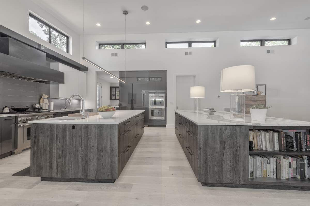 A kitchen with two large gray cabinets and white counters.