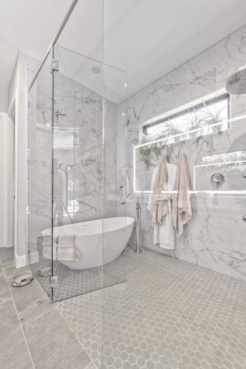 A bathroom with a tub and shower in it