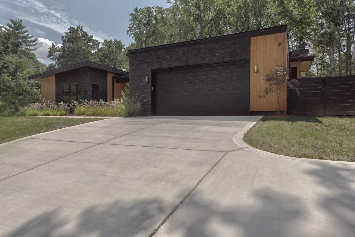 A large driveway with a garage door and concrete.