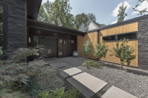 A modern house with a garden and trees