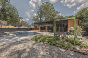 A digital rendering of a house with a pool.