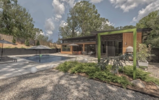 A digital rendering of a house with a pool.