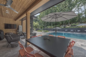 A table and chairs in front of an open patio door.
