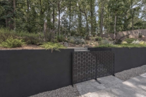 A fence with a gate and a metal screen.
