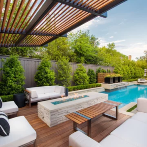 A patio with a fire pit and pool in it