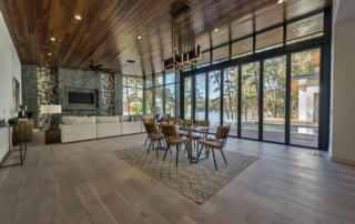 A dining room with a fireplace and a large glass door.