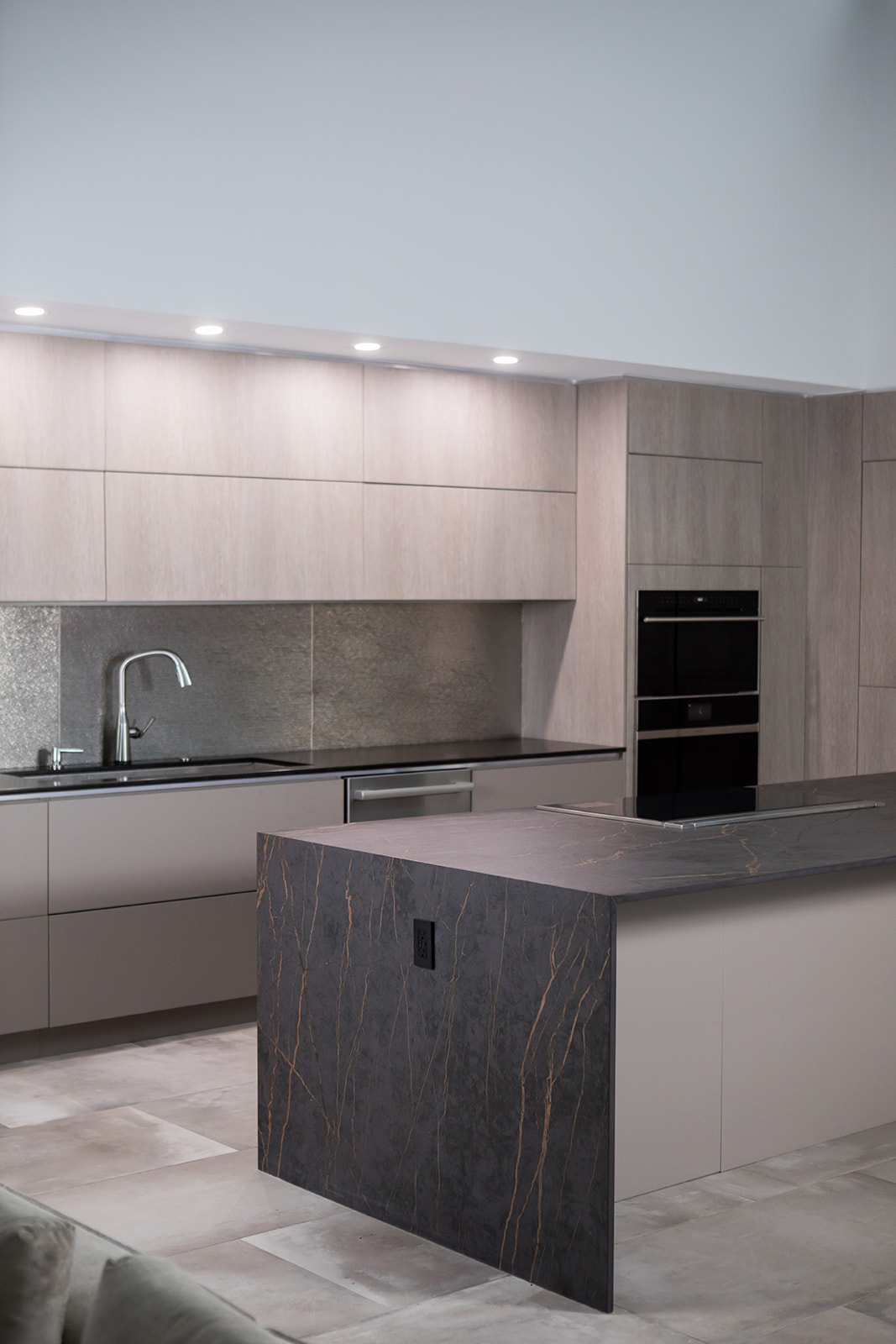 Modern gray slate minimalist kitchen with waterfall countertop