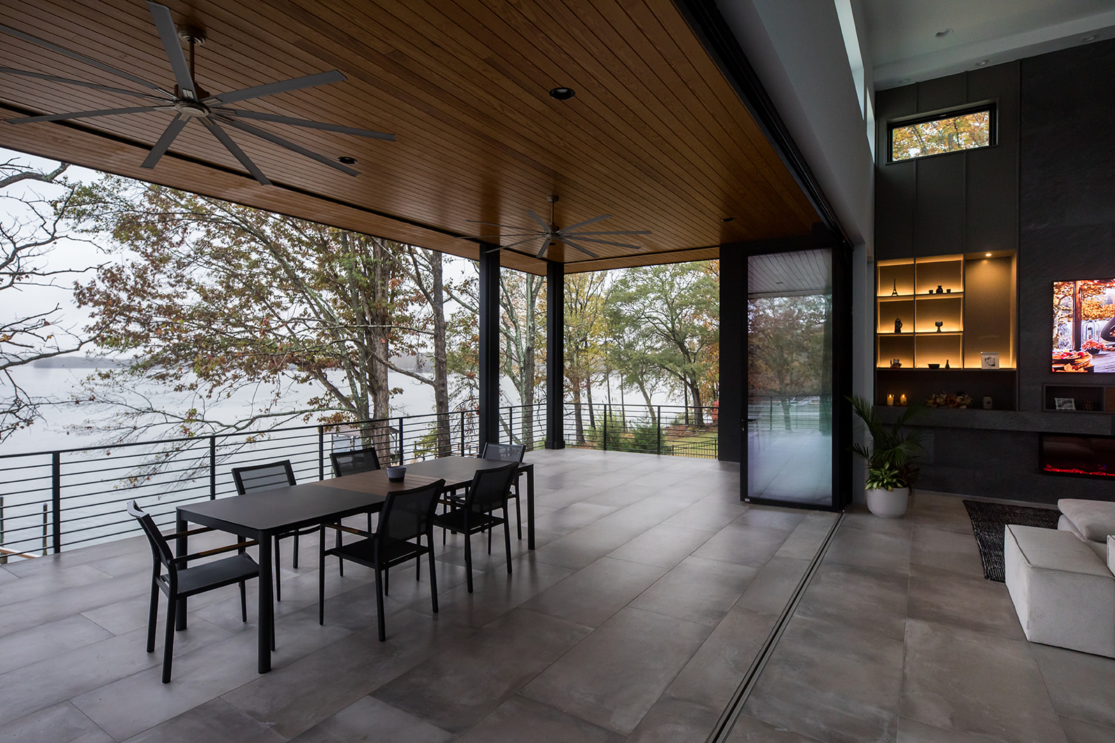 Modern outdoor dining area with folding french glass doors