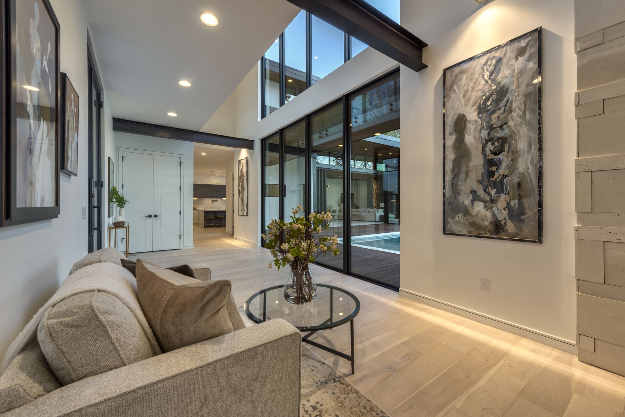 Exposed steel beam and floor-to-ceiling glass doors facing the pool at 6026 Midsomer Road